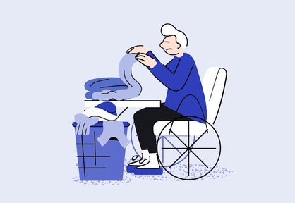 A person in a wheelchair folding laundry